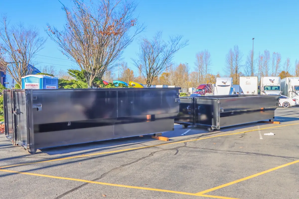 Professional dumpster rental service with roll-off container on residential driveway in Elgin